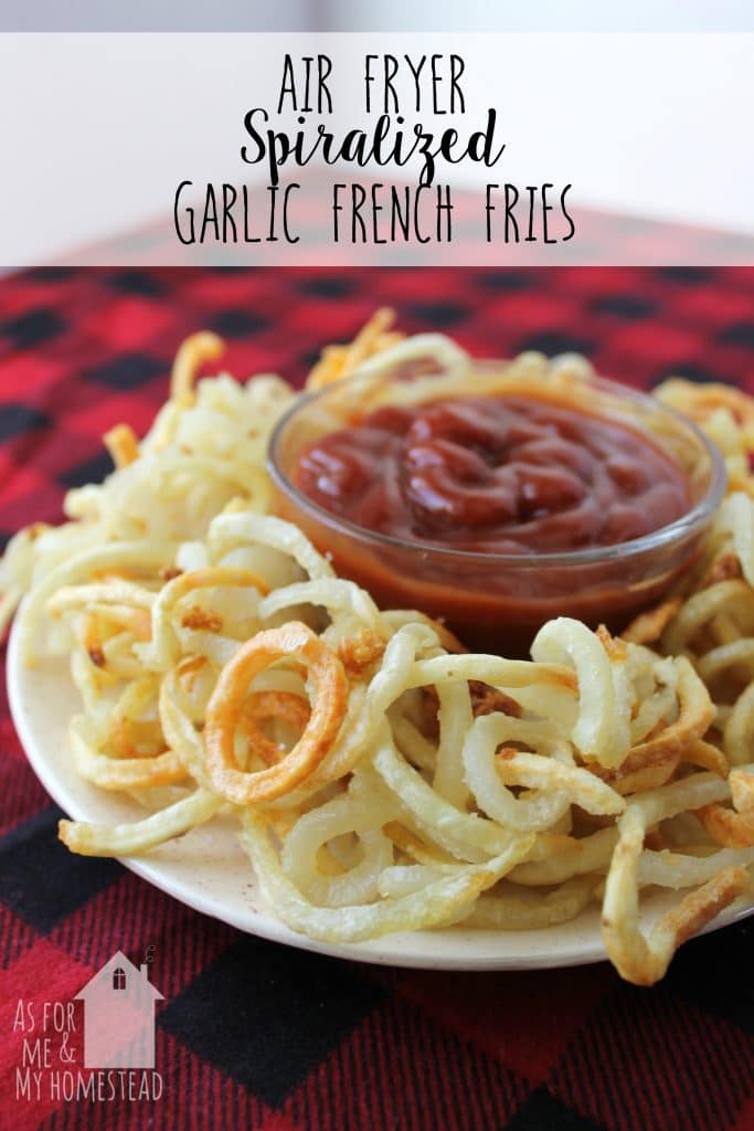 Heaping plate of Air Fryer Spiralized Garlic French Fries on a red plaid tablecloth